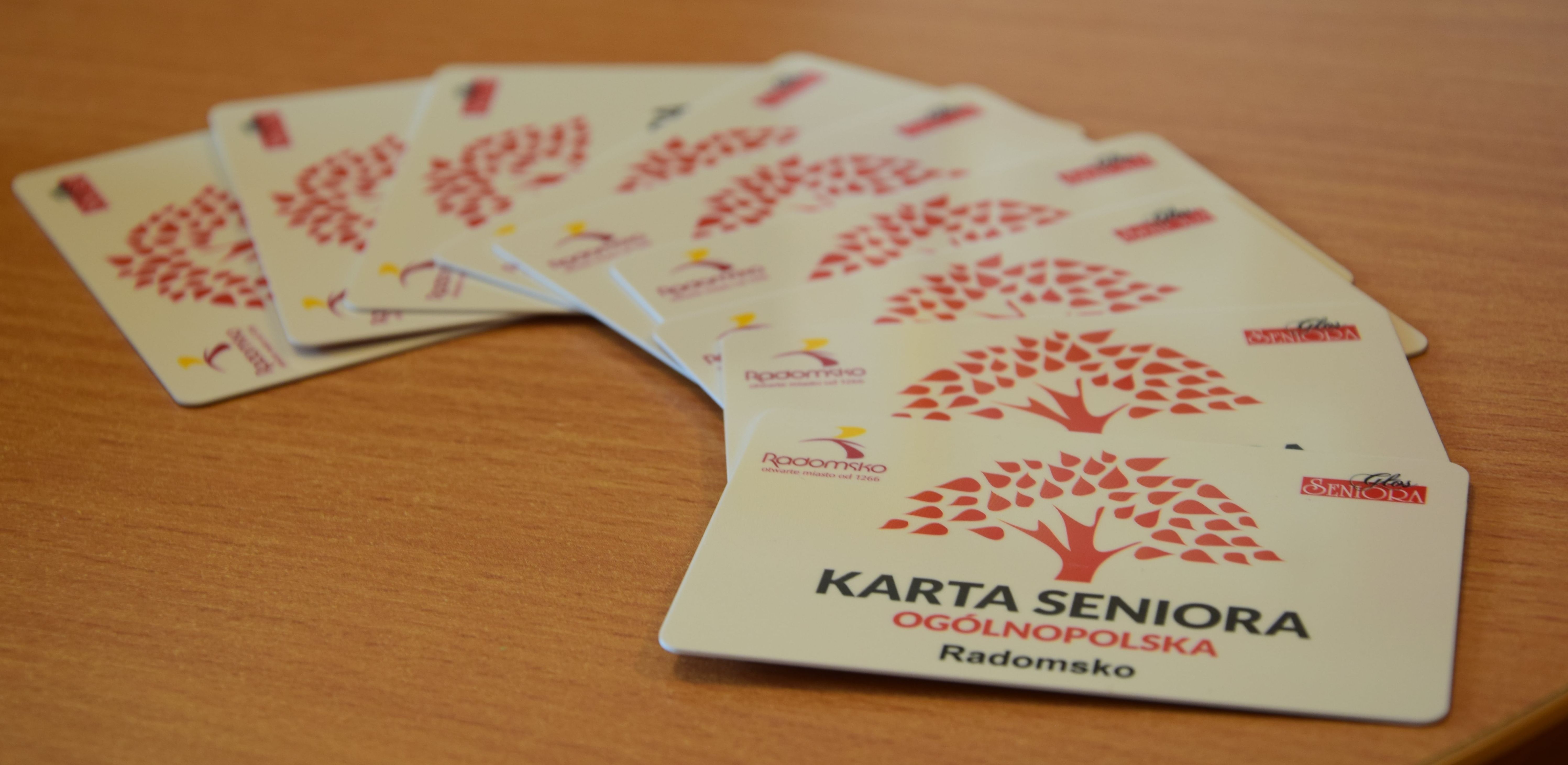 zdjęcie zawiera karty seniora ułożone na blacie biurkowym